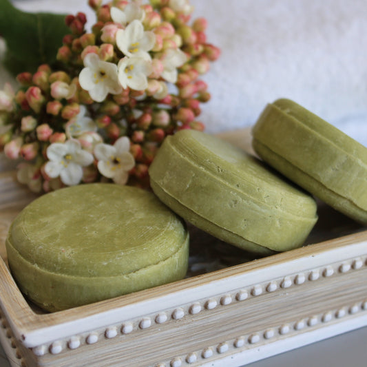Olive & Rosie, Dreamland Shampoo Bar for Dry Scalp on soap dish with Viburnum flowers